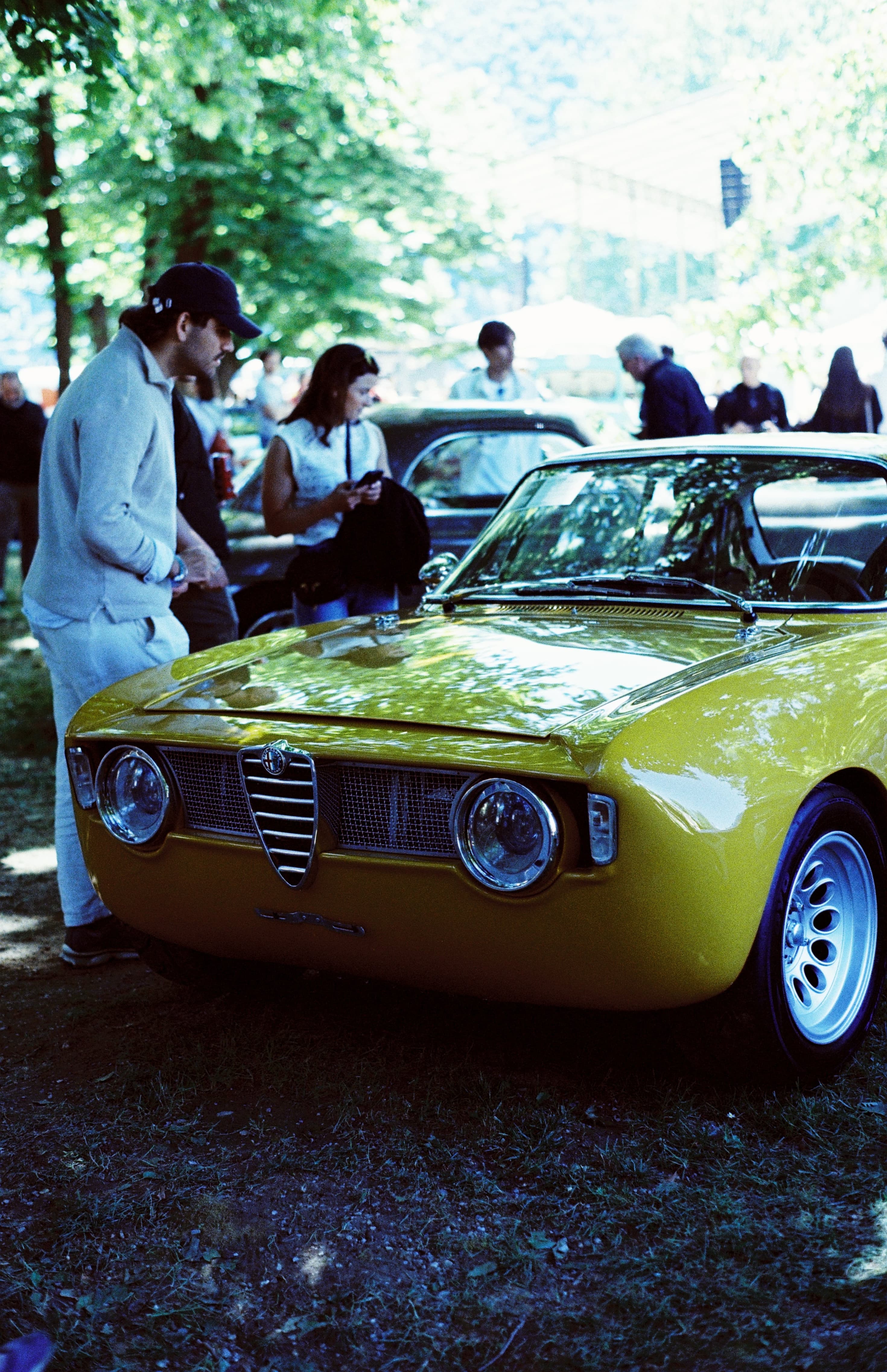 Yellow classic Alfa Romeo at an automotive gathering